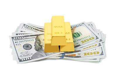 Shiny gold bars and dollar bills on white background