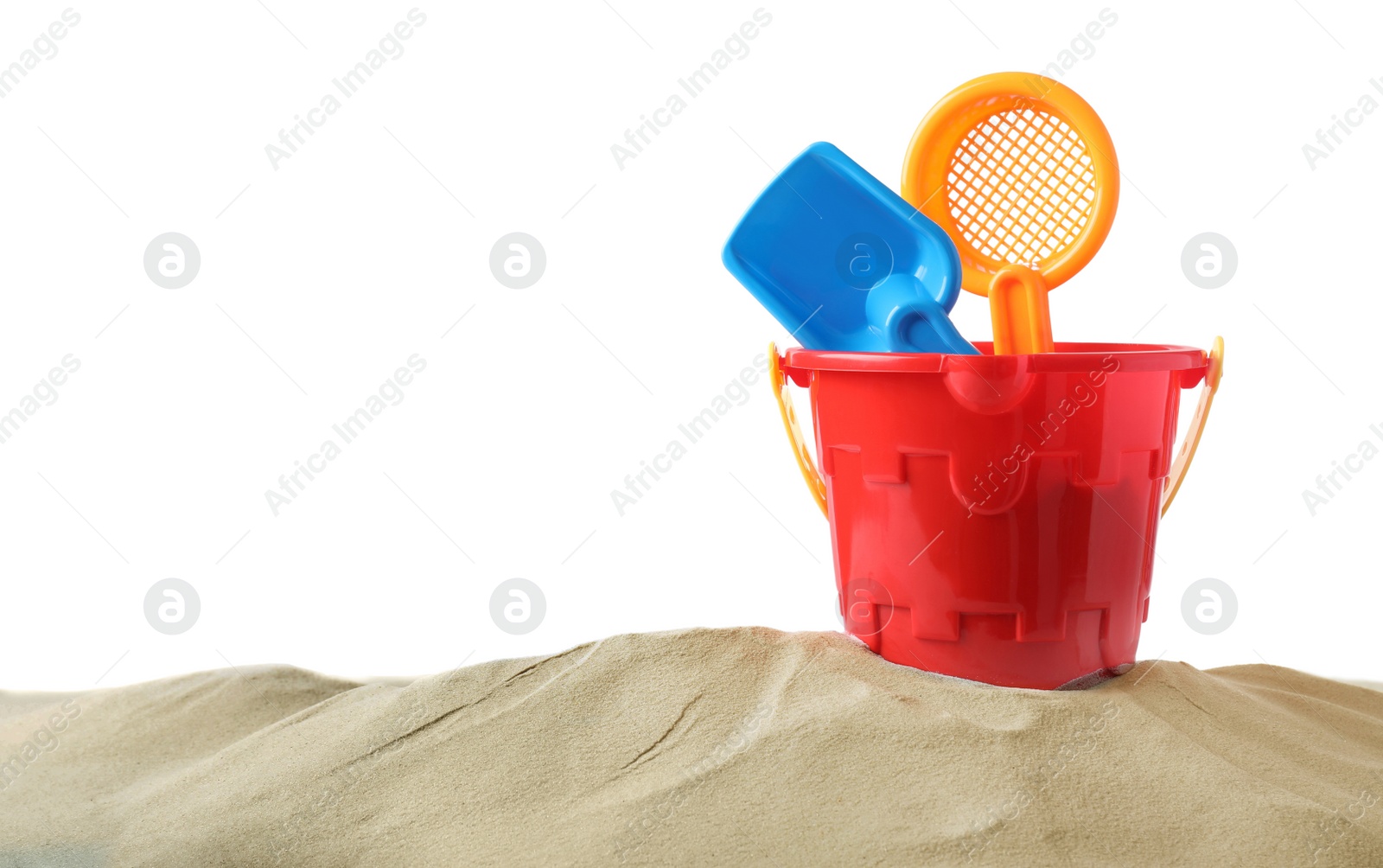 Photo of Plastic toy set with shovel on pile of sand