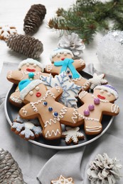 Photo of Delicious Christmas cookies, pine cones and fir branches on table