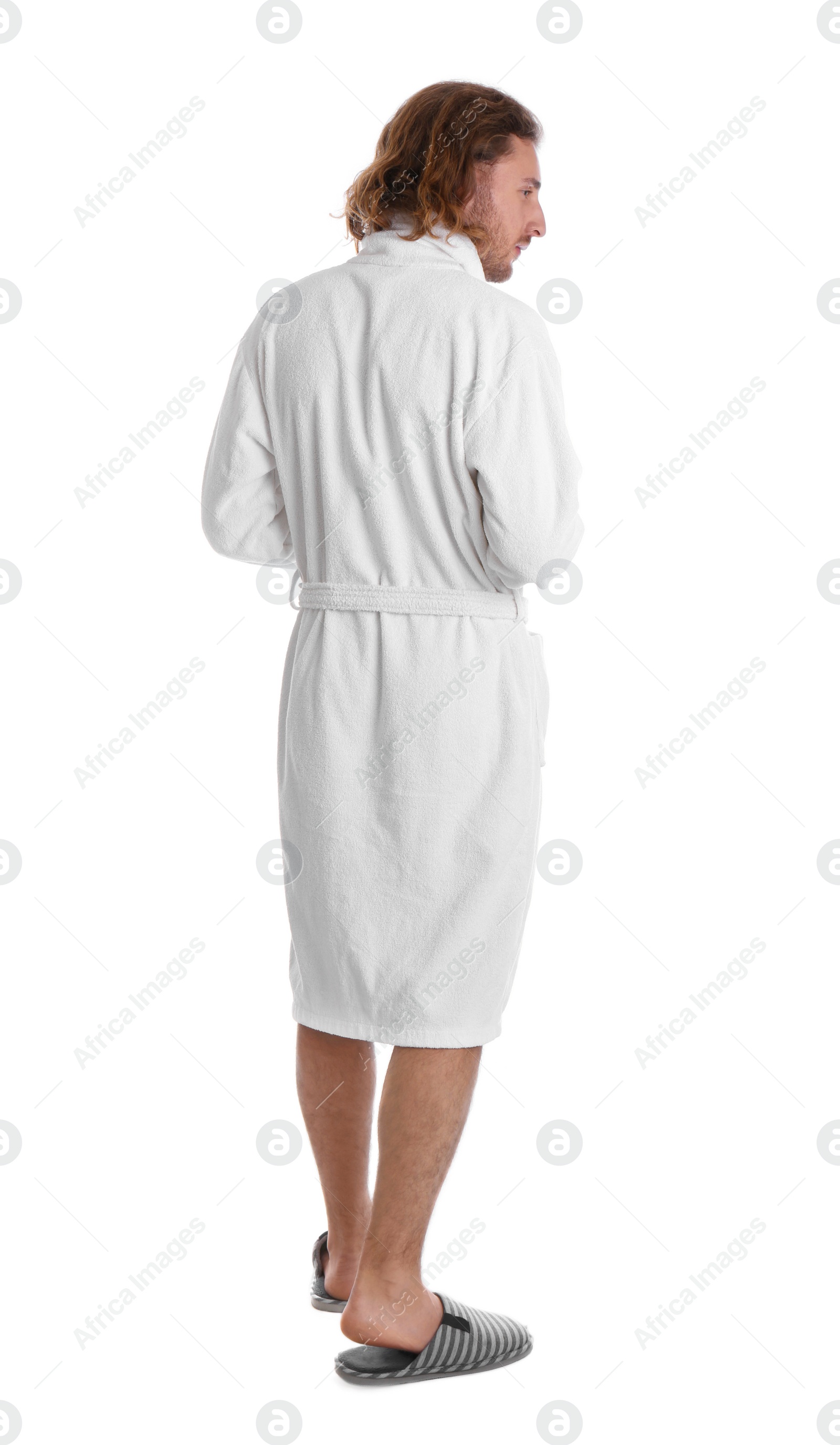 Photo of Young man in bathrobe on white background