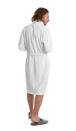 Young man in bathrobe on white background