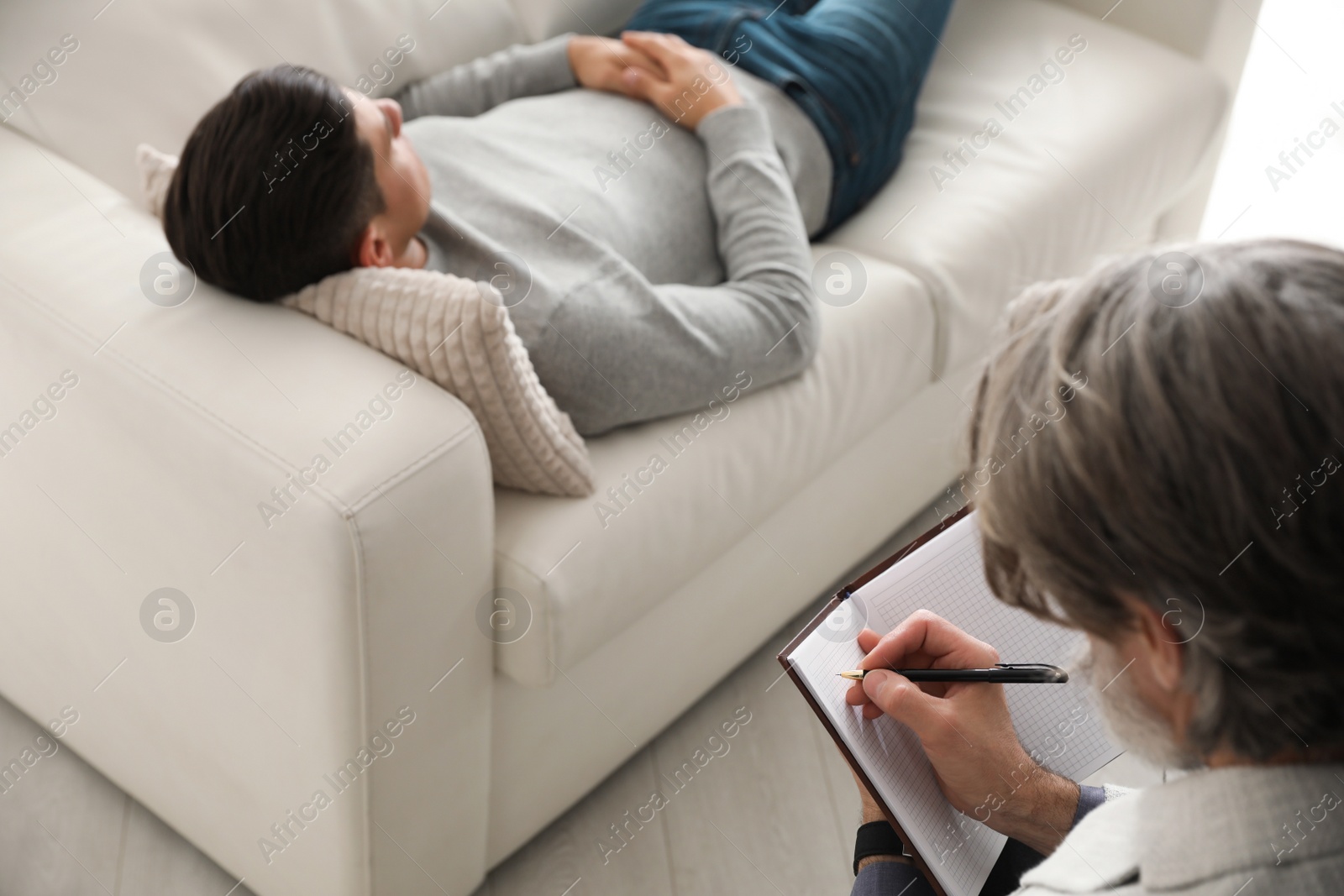 Photo of Psychotherapist and patient in office. Hypnotherapy session