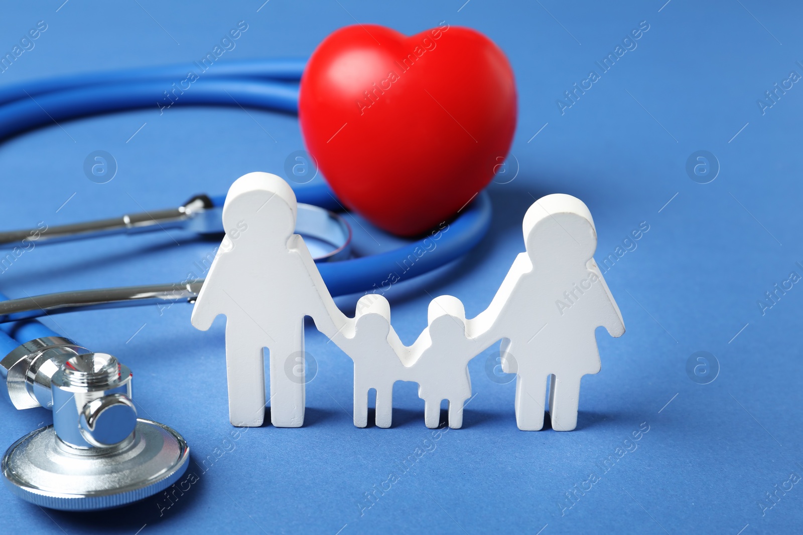 Photo of Family figure with stethoscope and heart on color background. Life insurance concept