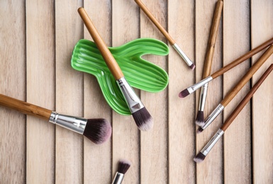 Makeup brushes on wooden background