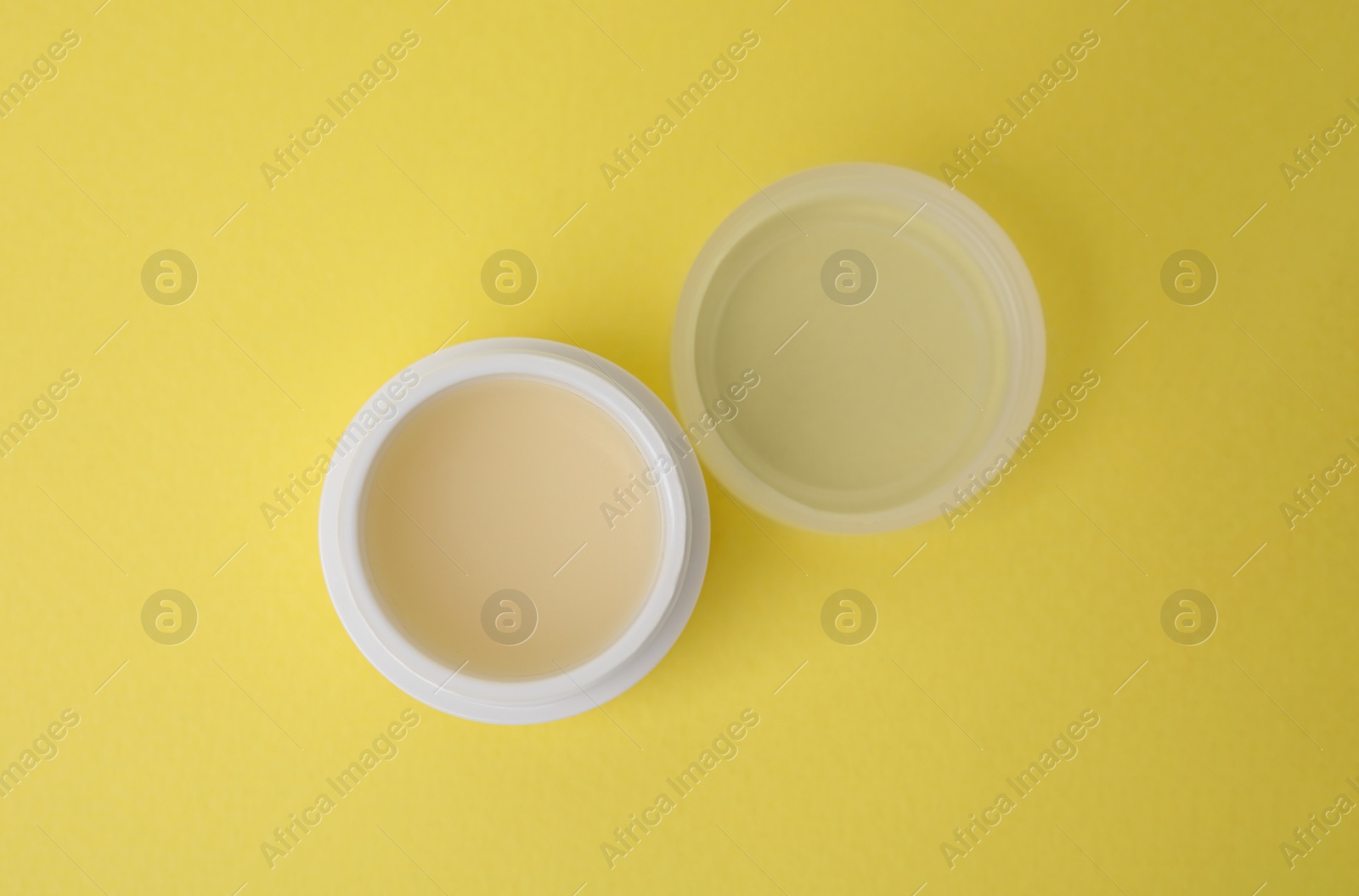 Photo of Jar of petroleum jelly on yellow background, top view