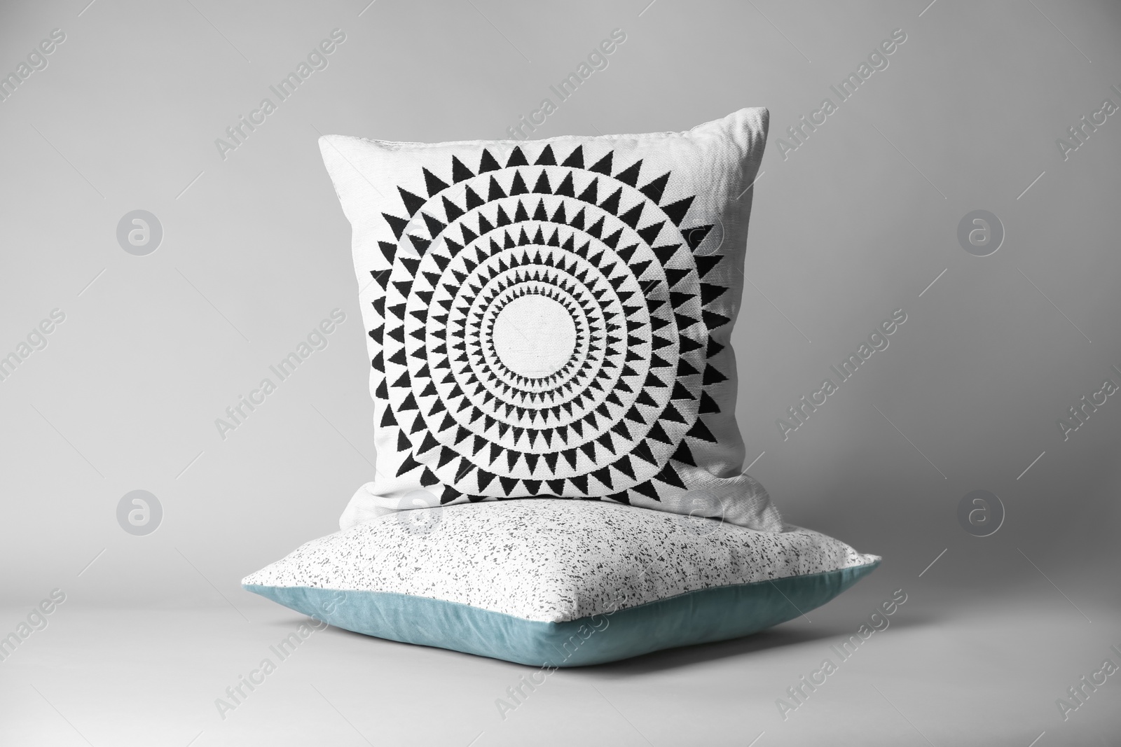 Photo of Soft decorative pillows on light background