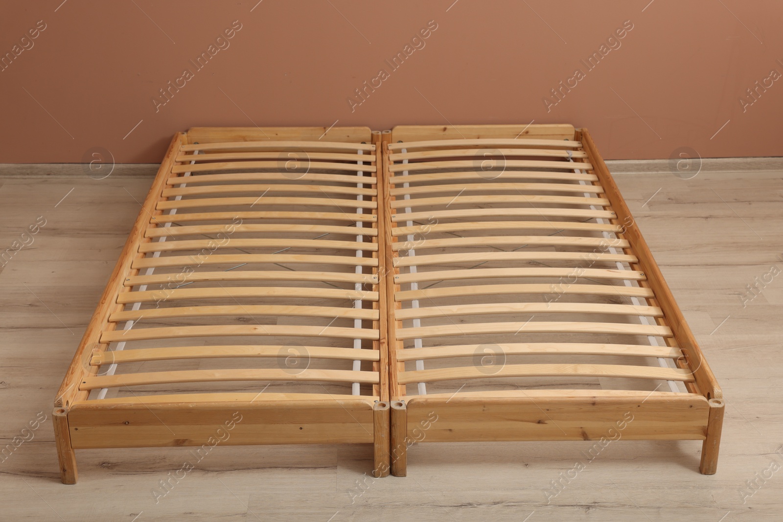 Photo of Wooden bed frame on floor in room