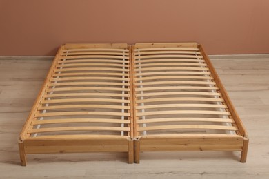 Photo of Wooden bed frame on floor in room