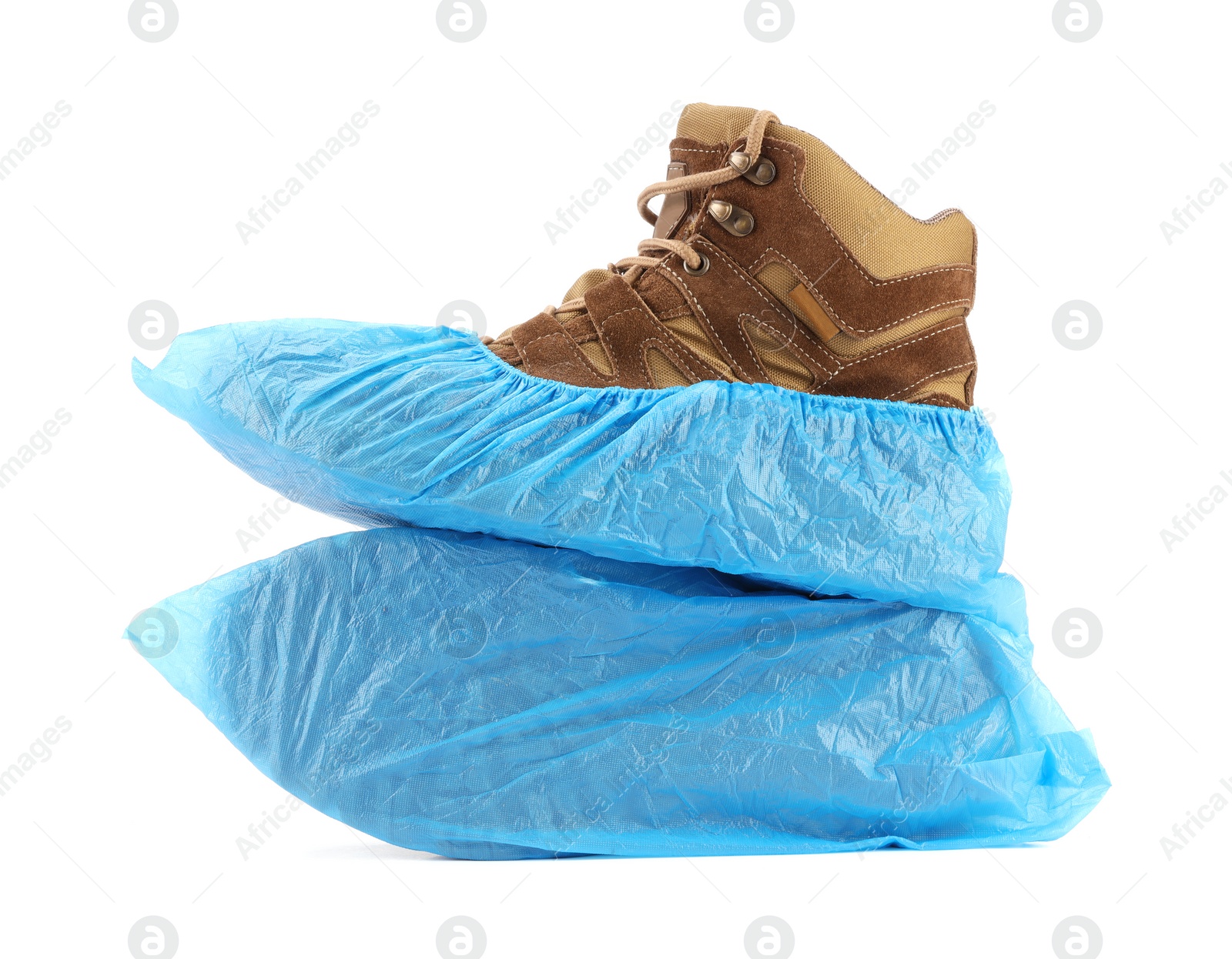 Photo of Boots in blue shoe covers isolated on white