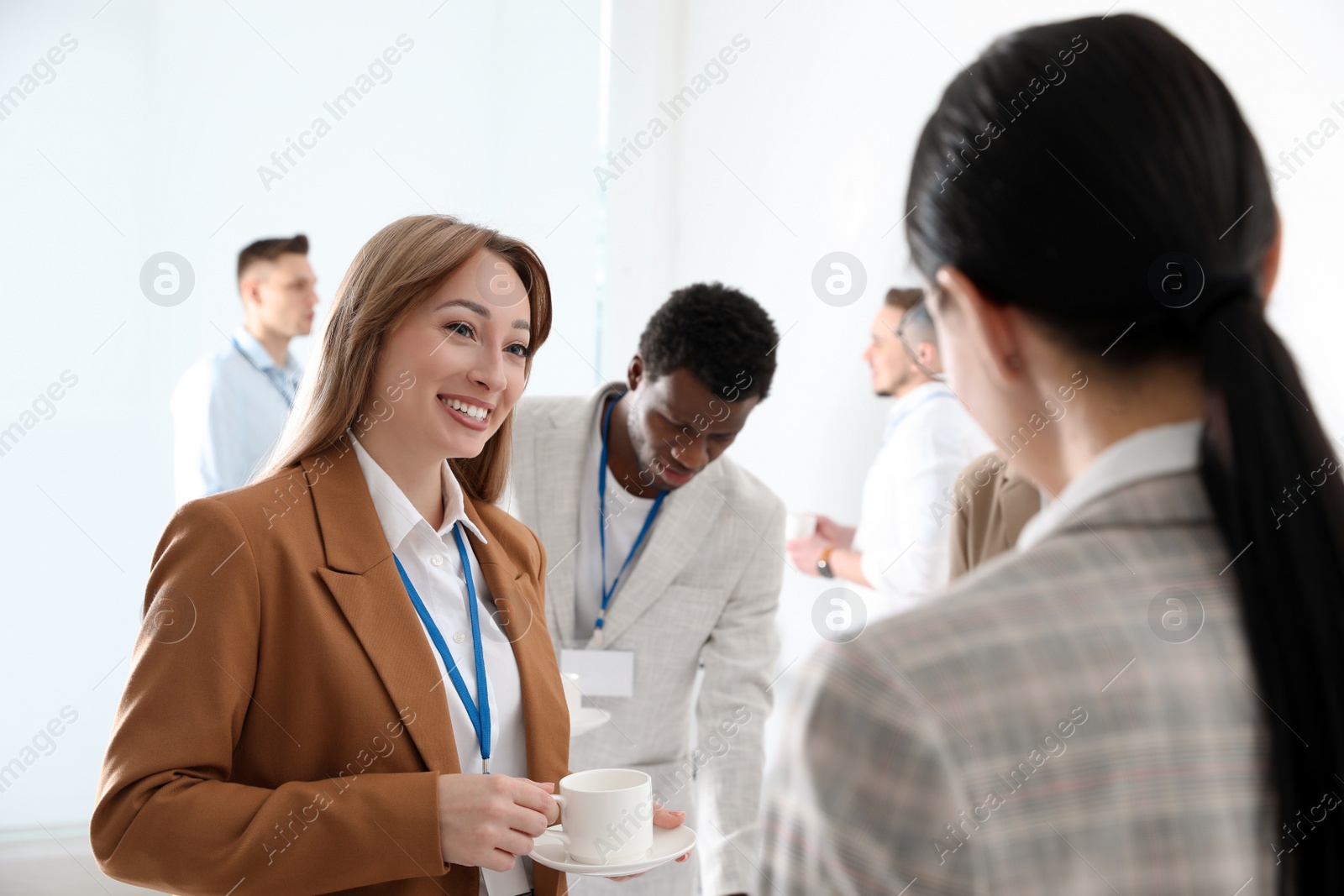 Photo of Group of people chatting during coffee break indoors