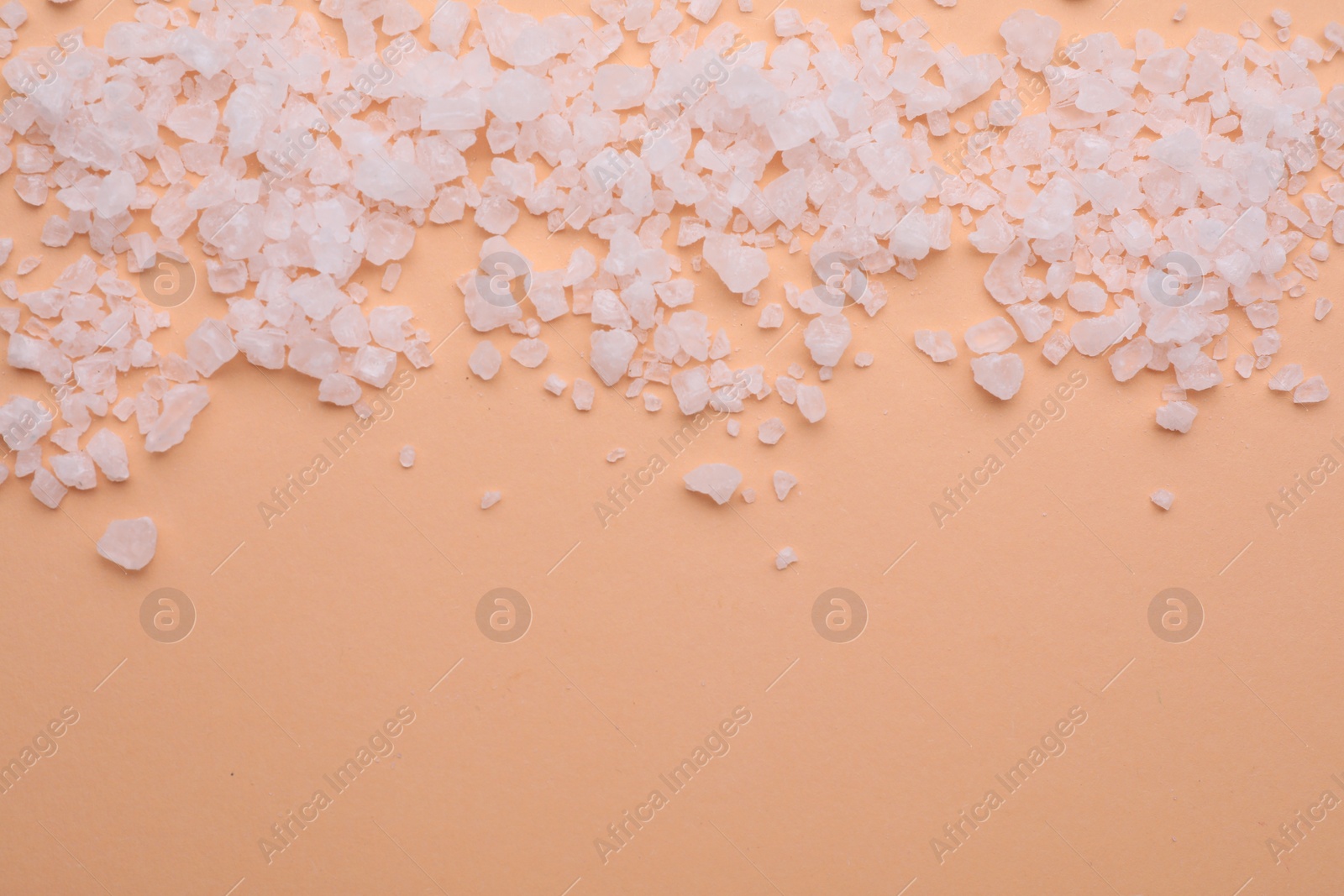 Photo of Sea salt on beige background, top view. Space for text