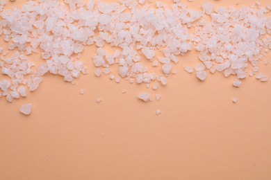 Photo of Sea salt on beige background, top view. Space for text