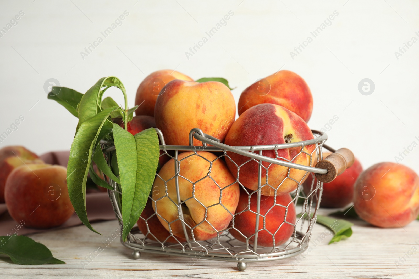 Photo of Fresh ripe juicy peaches on white wooden table