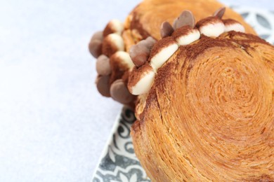 Tasty puff pastry. Supreme croissants with chocolate chips and cream on light table, closeup. Space for text