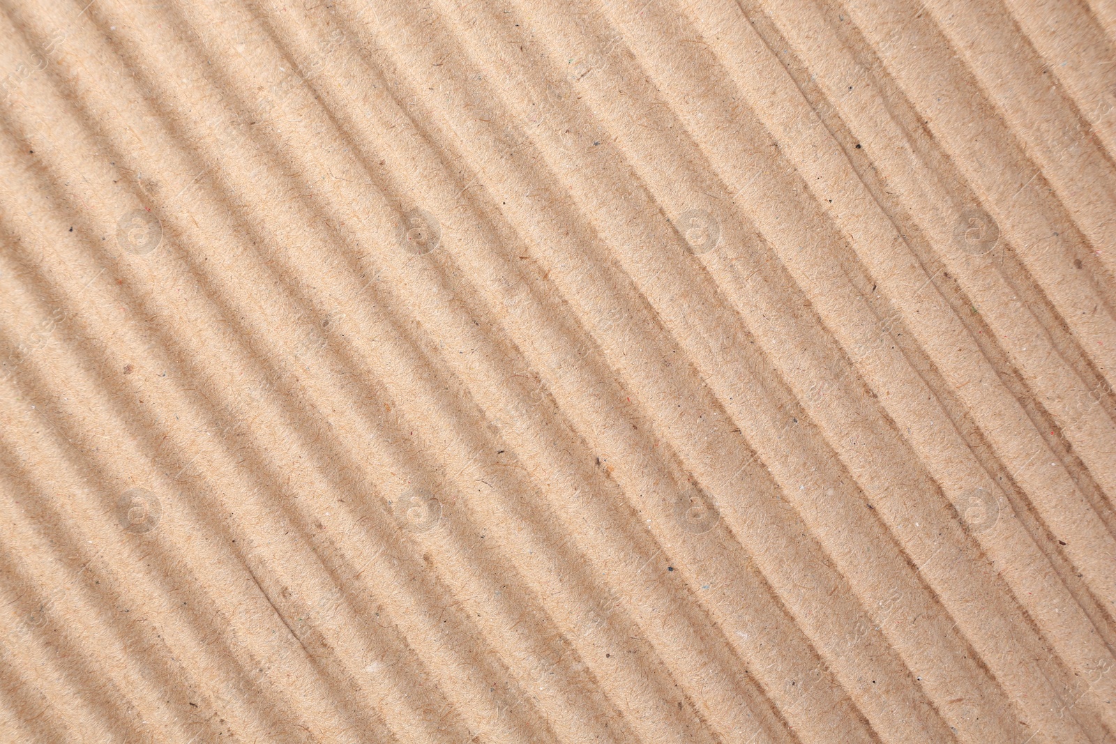 Photo of Texture of beige corrugated paper sheet as background, closeup