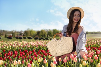 Photo of Woman in beautiful tulip field on sunny day