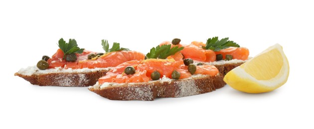 Tasty canapes with salmon, capers, lemon and cream cheese isolated on white