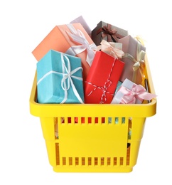 Photo of Shopping basket full of gift boxes on white background