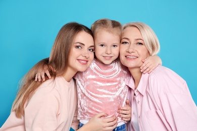 Photo of Portrait of young woman, her daughter and mature mother on color background