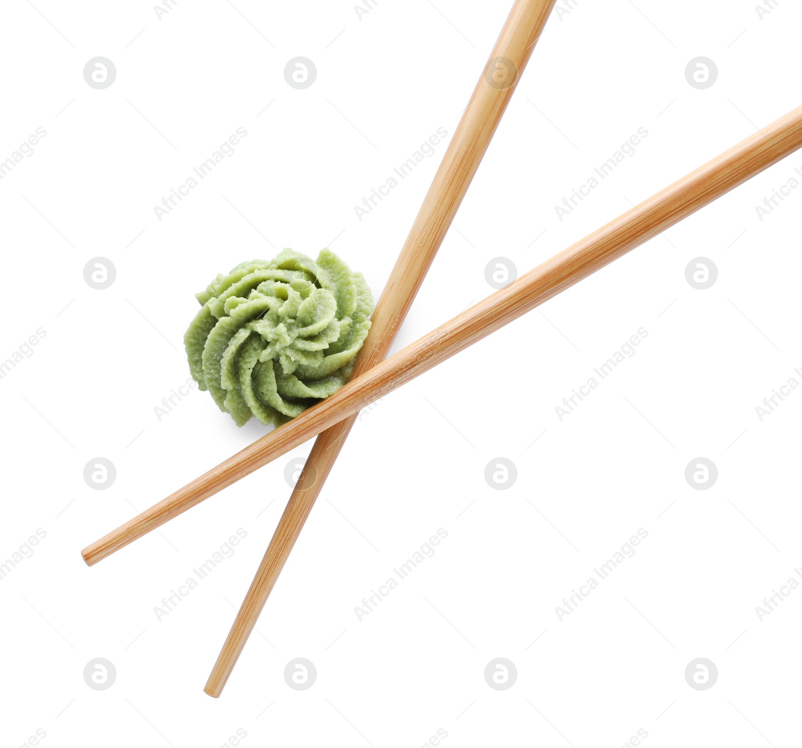 Photo of Swirl of wasabi paste and chopsticks on white background, top view