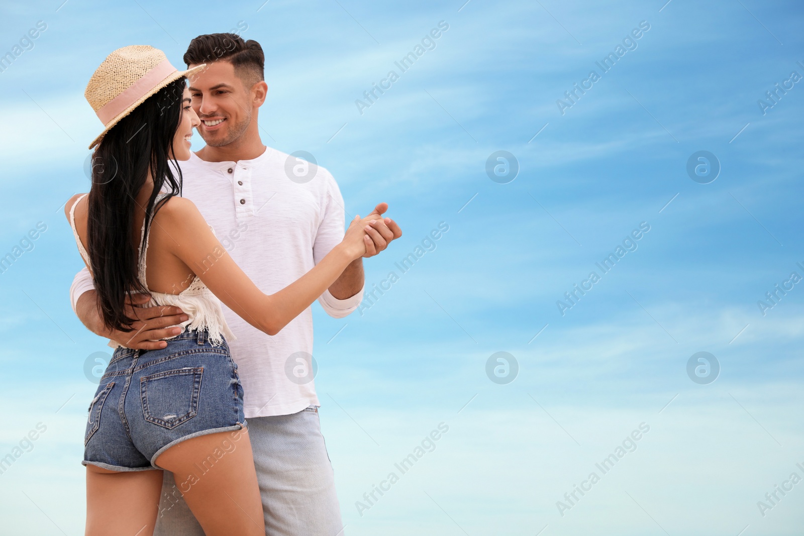 Photo of Lovely couple dancing outdoors. Space for text