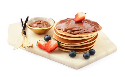 Photo of Delicious pancakes with chocolate paste, berries and cutlery isolated on white