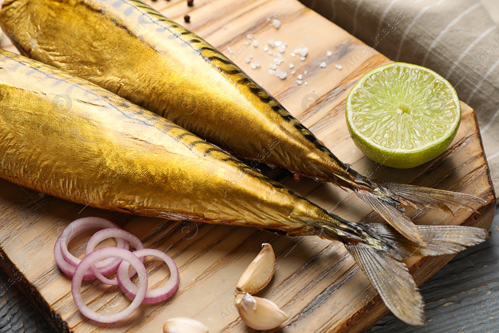 Photo of Tasty smoked fish on wooden table, closeup