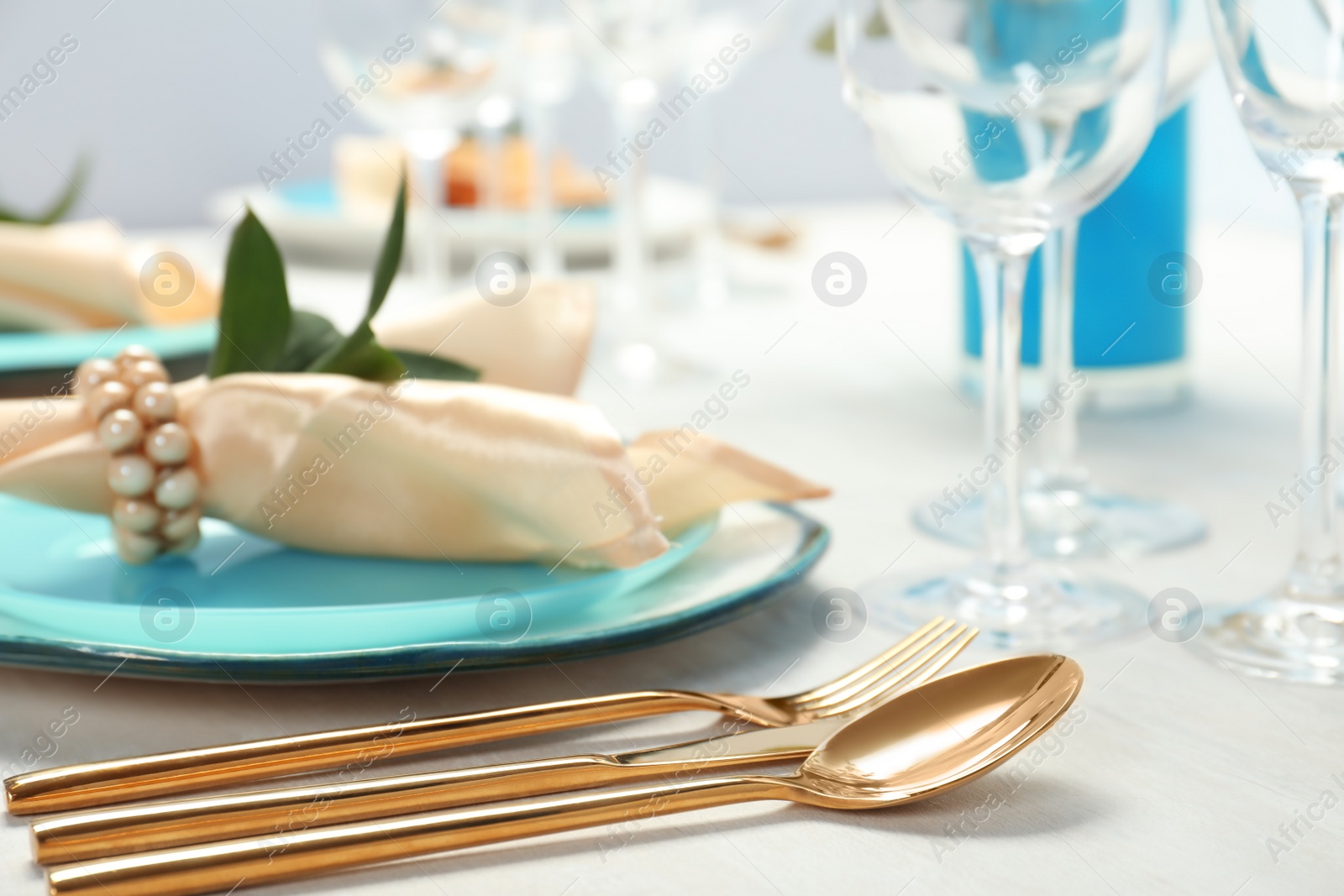 Photo of Beautiful table setting with cutlery, glasses, napkin and plate, closeup