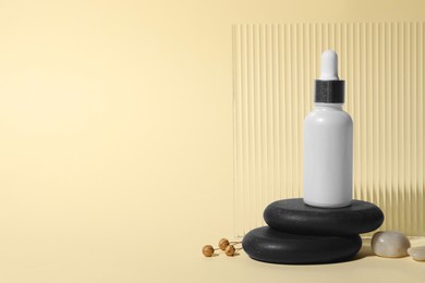 Composition with bottle of cosmetic serum on beige background. Space for text