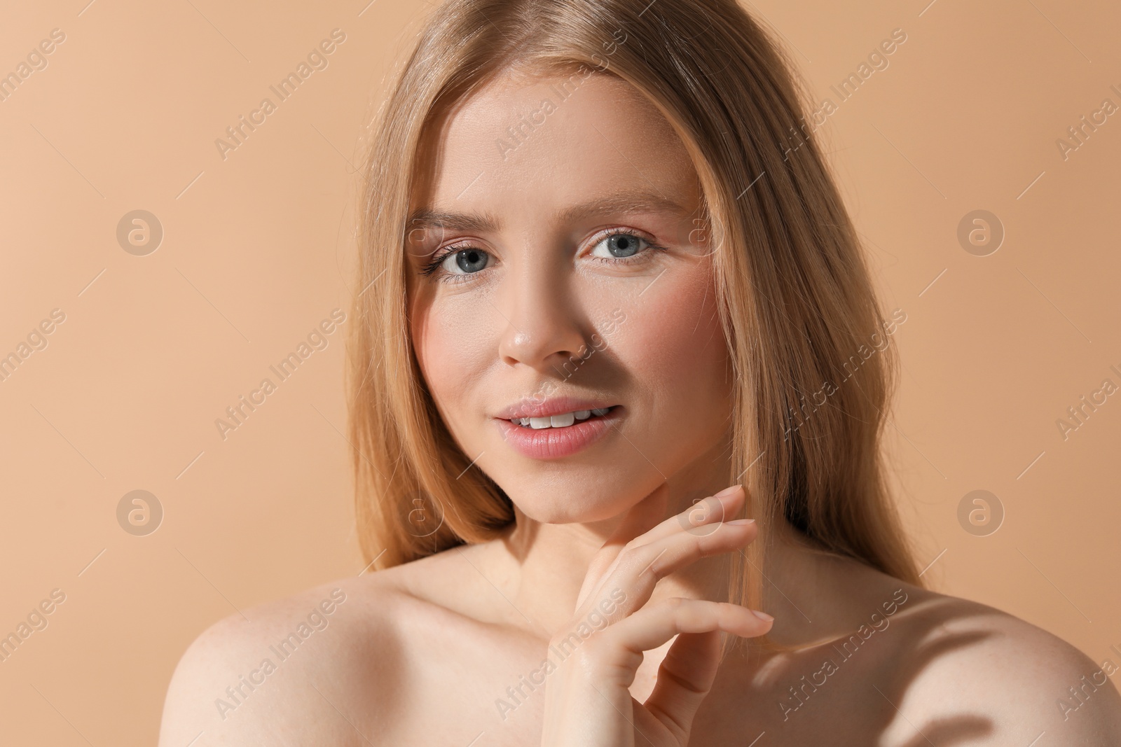 Photo of Beautiful young woman posing on beige background