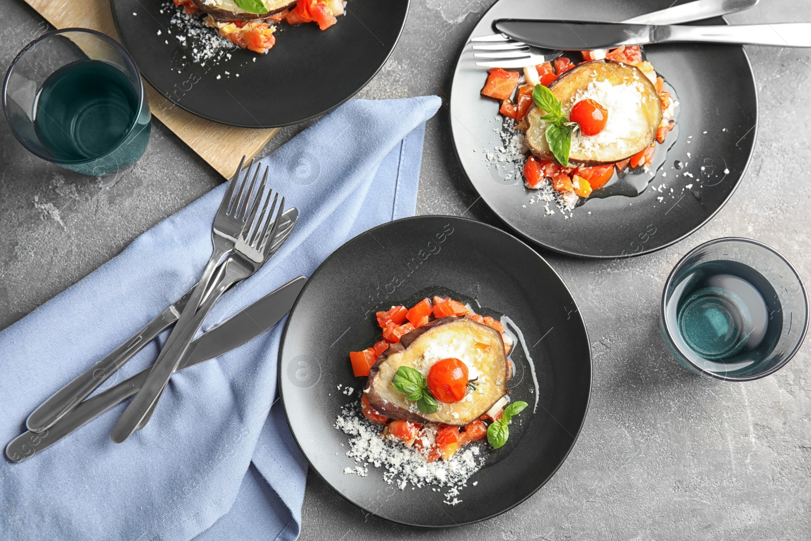 Photo of Flat lay composition with baked eggplant, tomatoes and cheese served on table