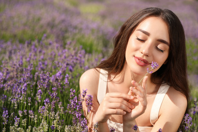 Young woman in lavender field on summer day