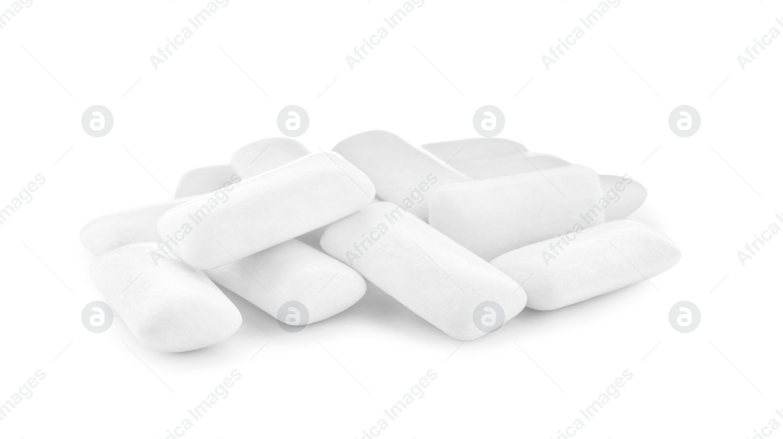 Photo of Heap of chewing gum pieces on white background