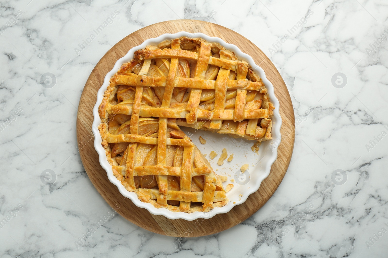 Photo of Tasty homemade quince pie on white marble table, top view