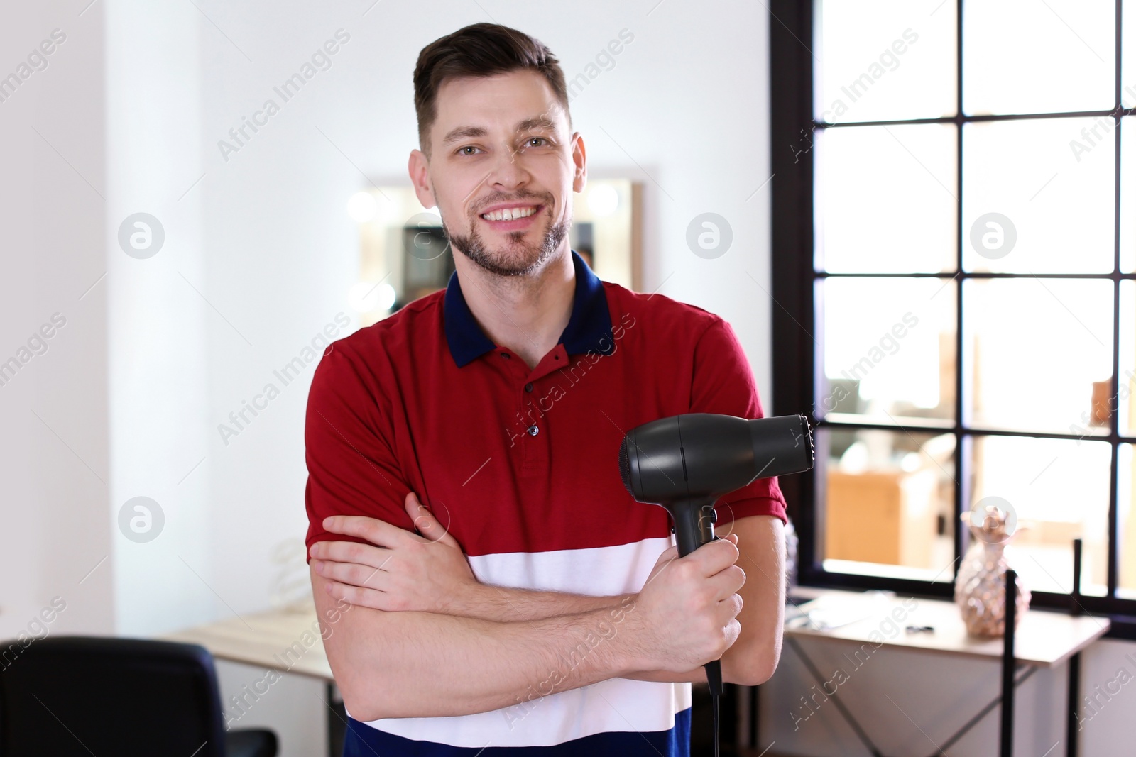 Photo of Professional hairdresser in beauty salon