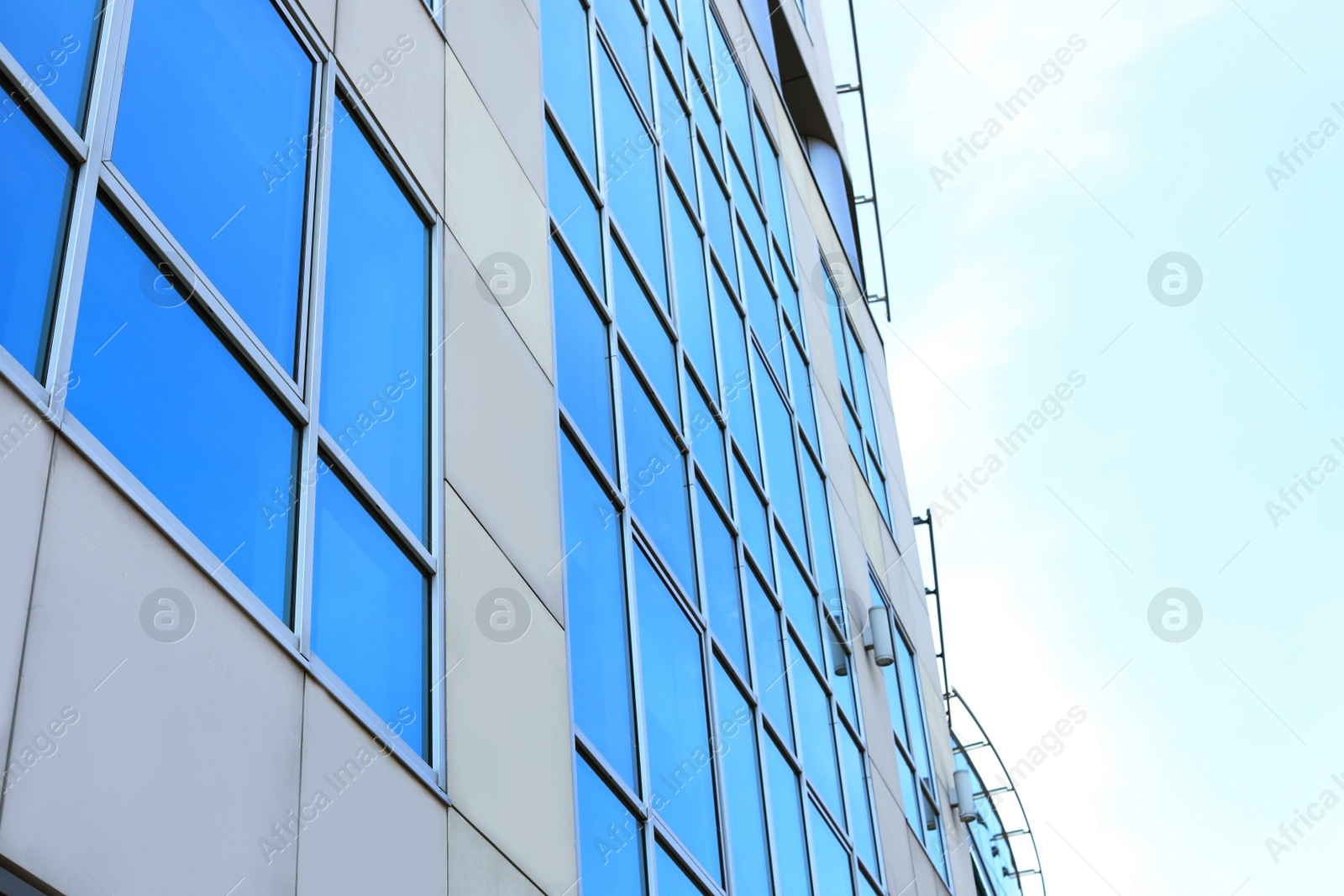 Photo of Building with tinted windows, outdoors. Modern architectural design