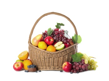 Photo of Wicker basket with different fruits and berries on white background