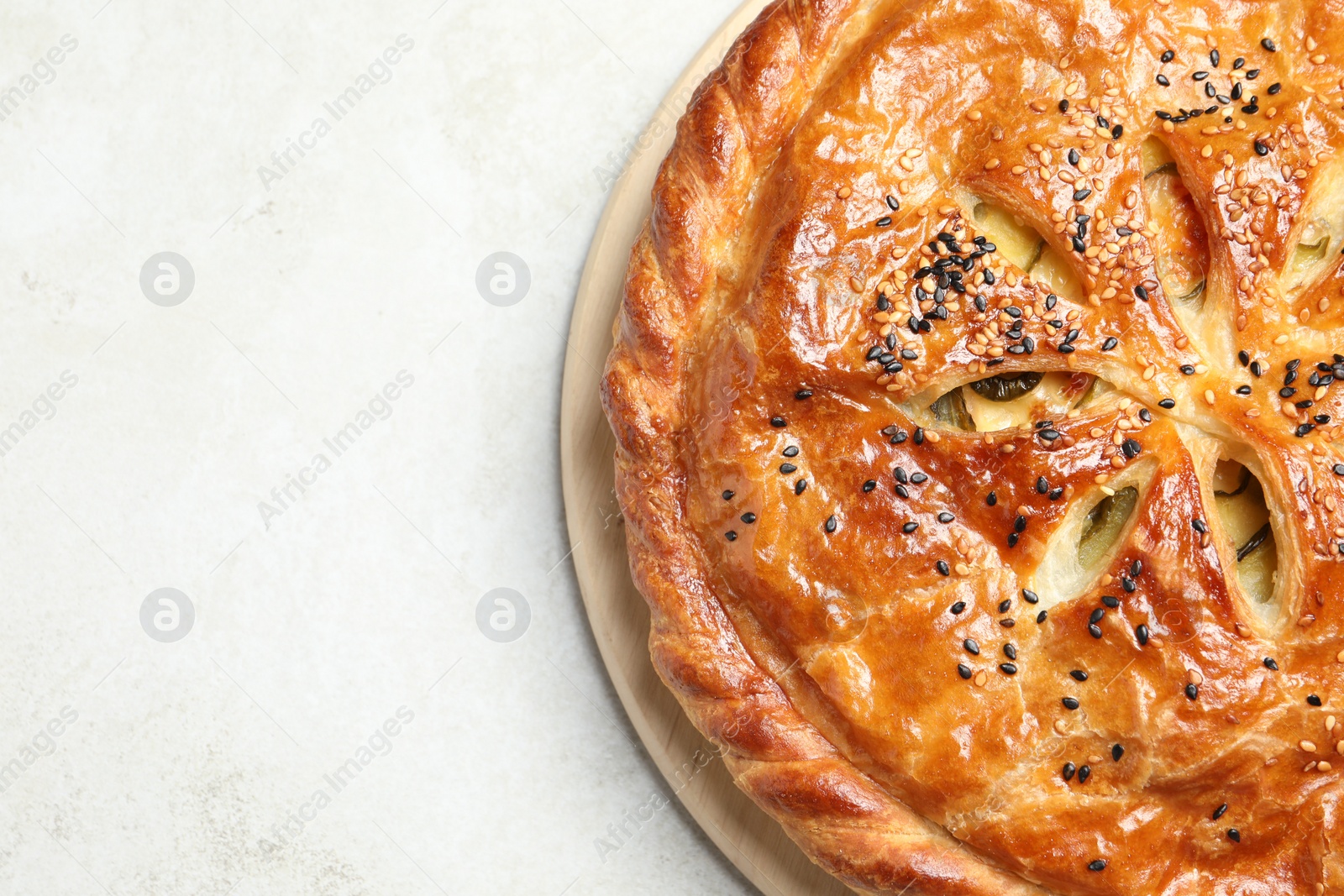 Photo of Tasty homemade pie with filling on light table, top view. Space for text