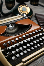 Photo of Vintage typewriter on grey wooden table, closeup. Detective's workplace