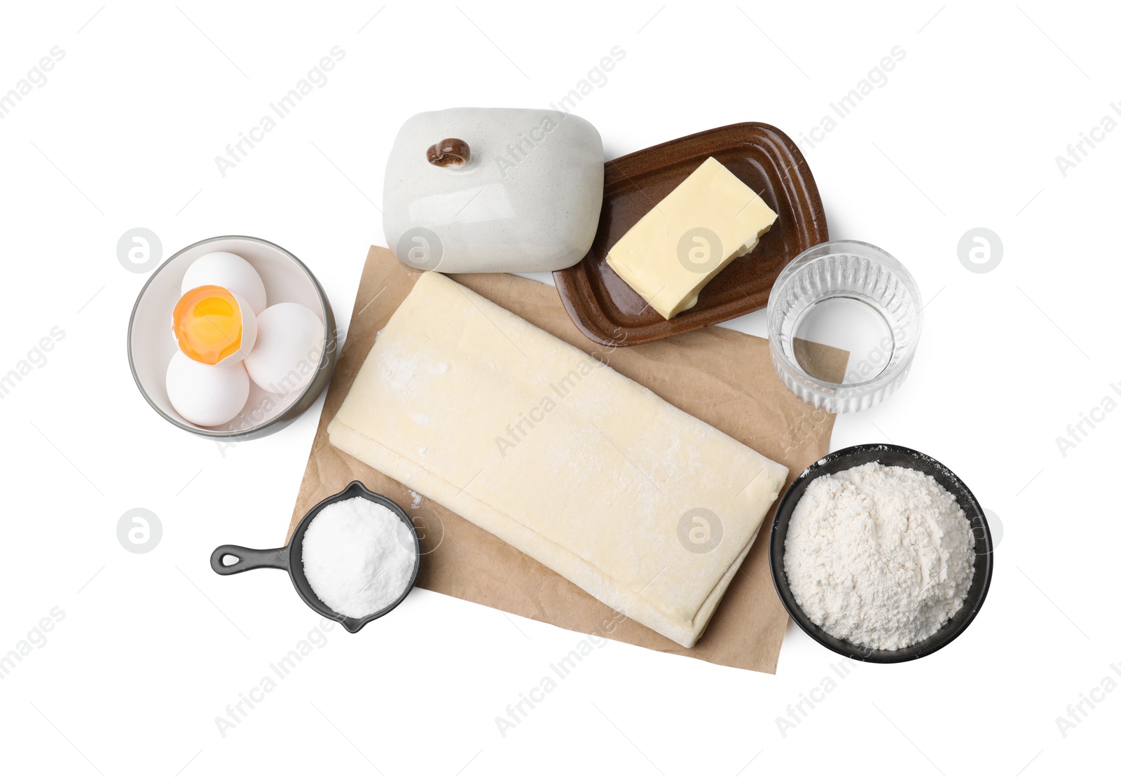 Photo of Raw puff pastry dough and ingredients isolated on white, top view