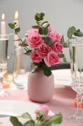Photo of Romantic dinner. Bouquet with beautiful pink roses on table