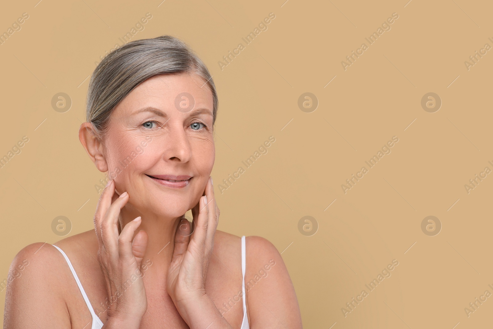 Photo of Portrait of senior woman with aging skin on beige background, space for text. Rejuvenation treatment