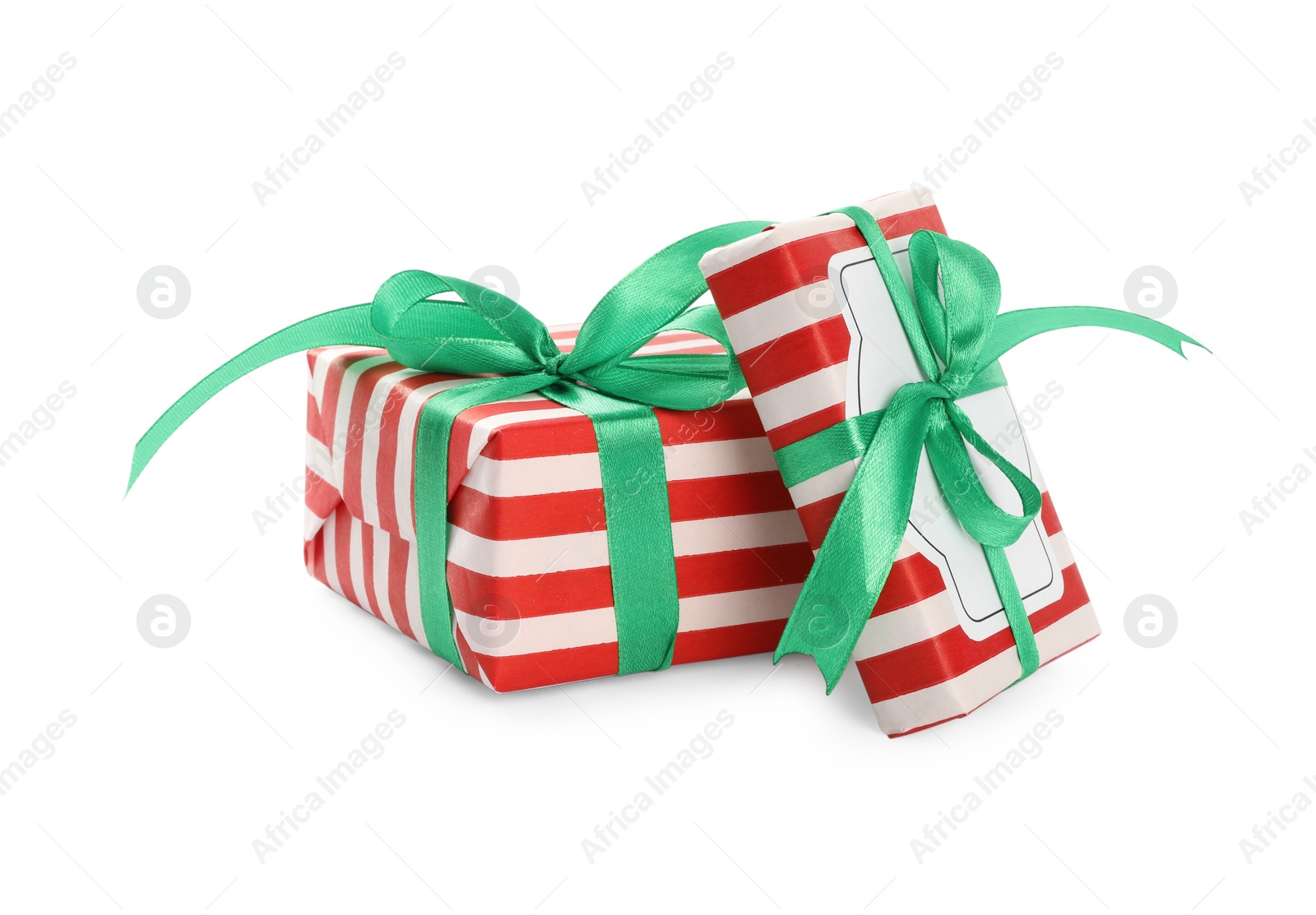 Photo of Christmas gift boxes decorated with green bows on white background