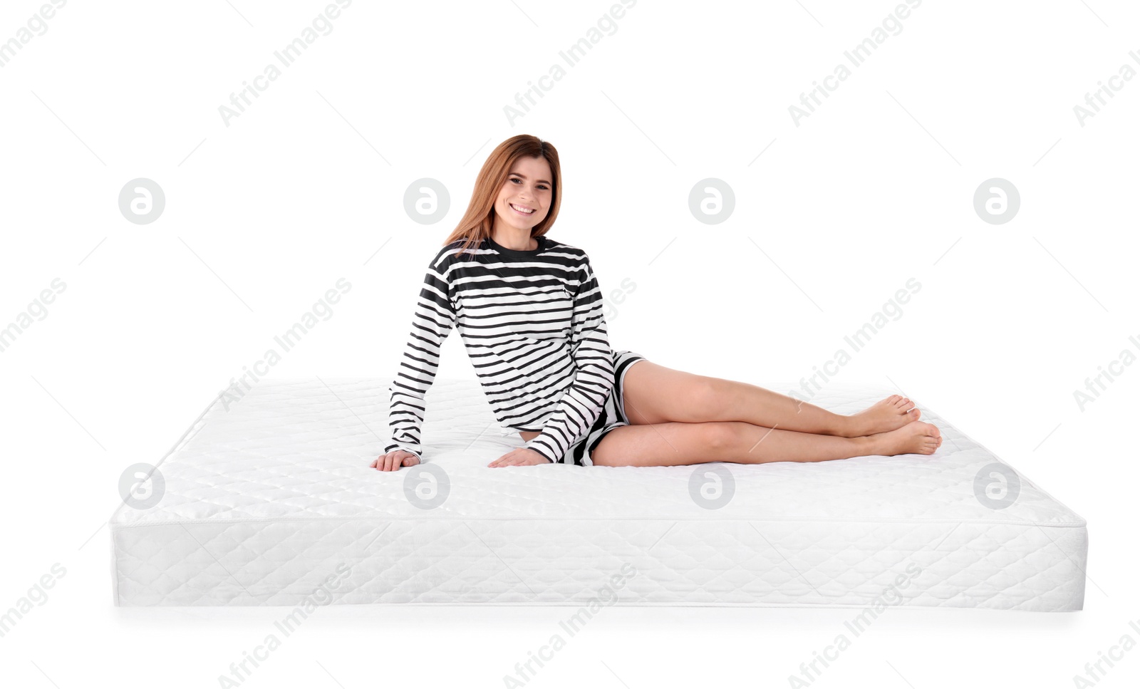 Photo of Woman sitting on mattress against white background