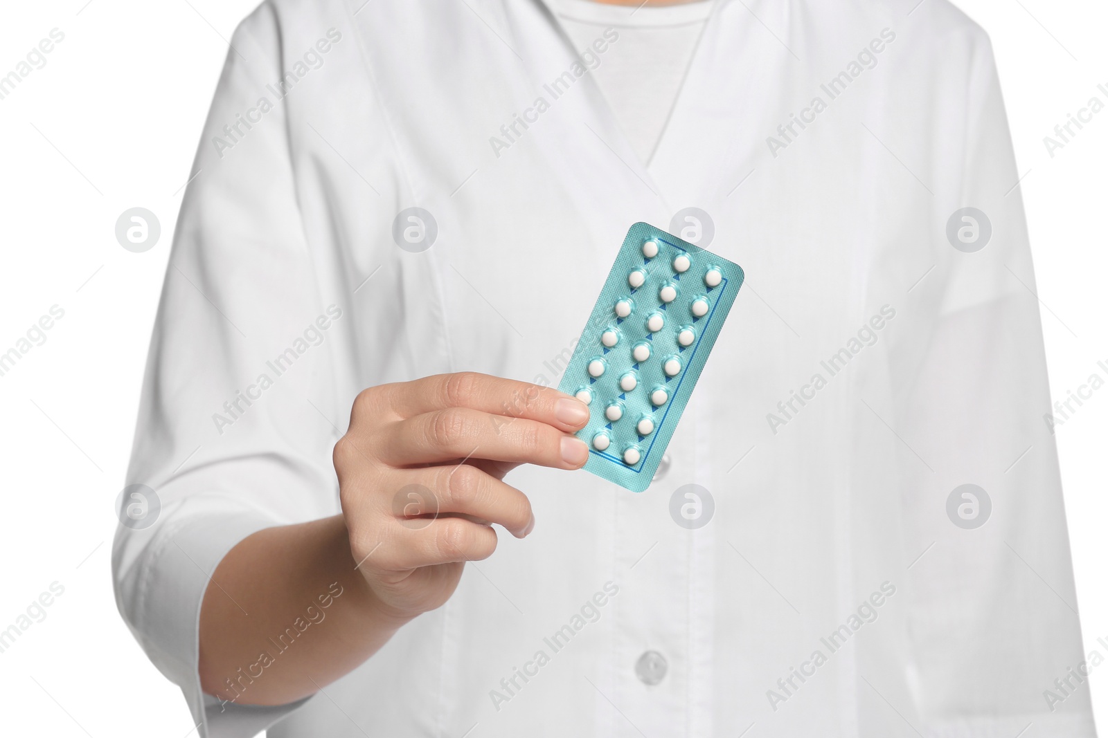 Photo of Doctor holding blister of oral contraception pills against white background, focus on hand