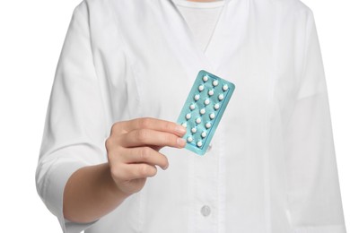 Photo of Doctor holding blister of oral contraception pills against white background, focus on hand
