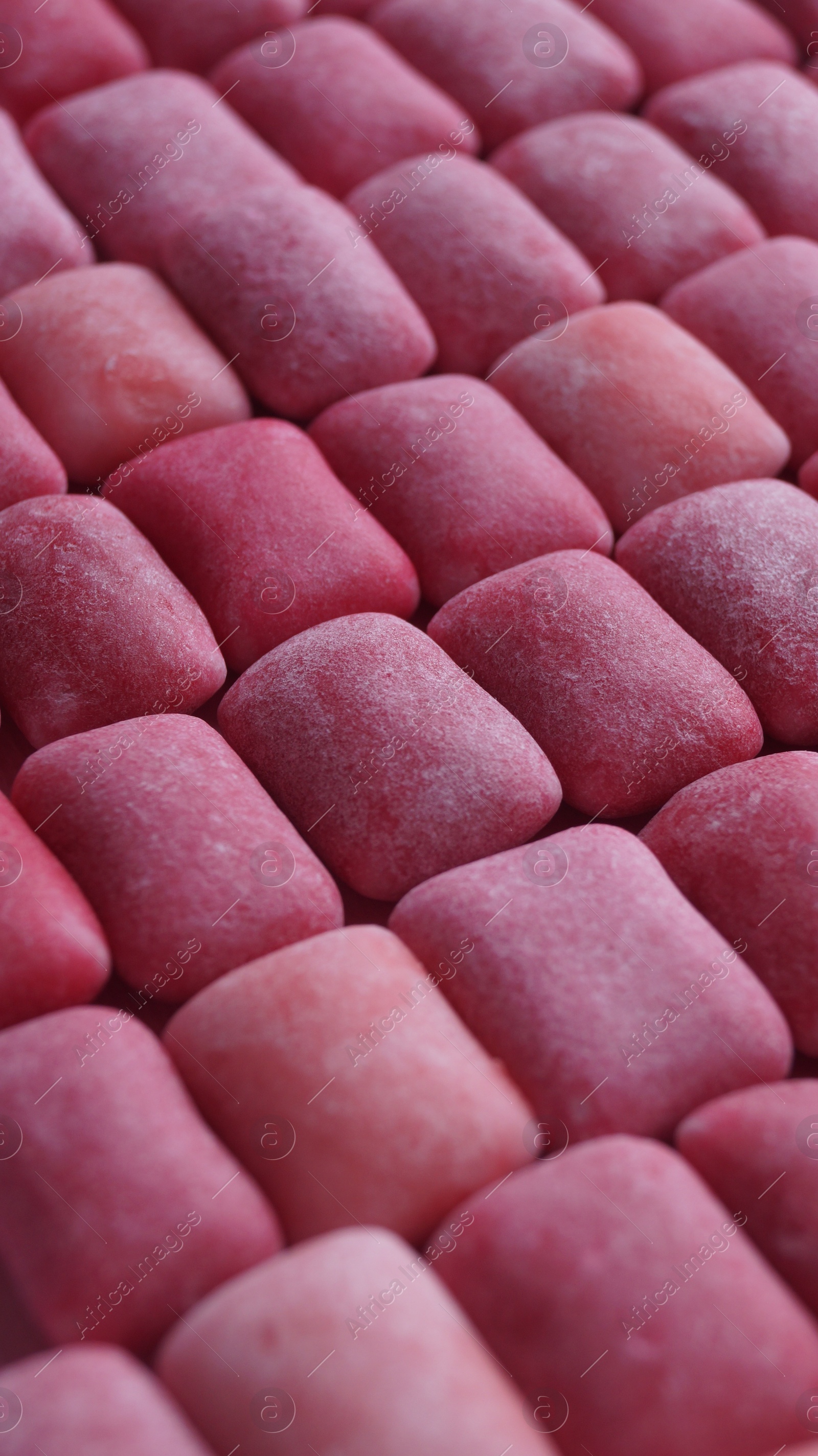 Photo of Many pink chewing gums as background, closeup