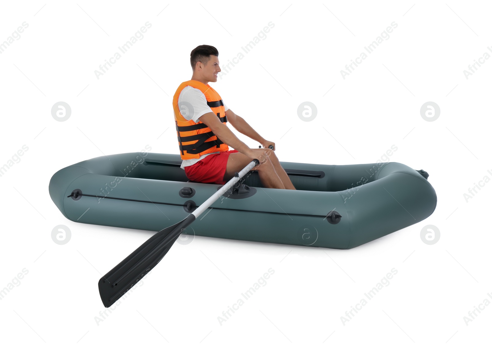 Photo of Man in life vest rowing inflatable rubber boat on white background