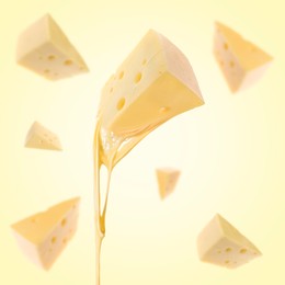 Pieces of cheese falling on yellow background