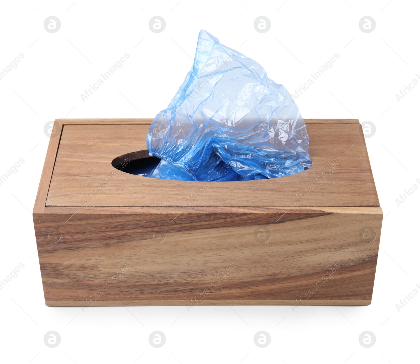 Photo of Blue medical shoe covers in wooden box isolated on white